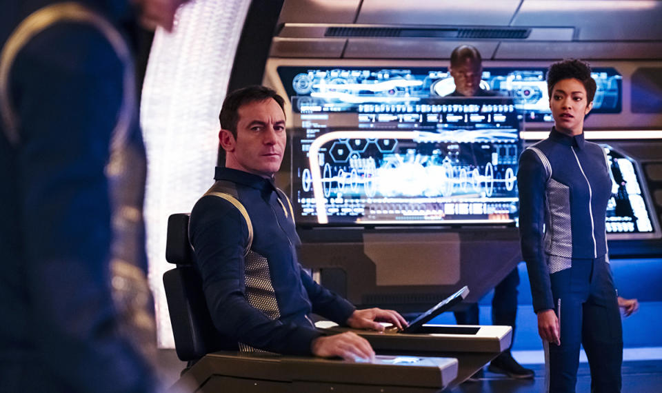 Gabriel Lorca (Jason Isaacs) sits in the captain's chair, with Michael Burnham (Sonequa Martin-Green) to the right on "Star Trek: Discovery." <cite>Jan Thijs/CBS</cite>